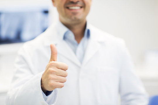 close up of doctor showing thumbs up at hospital