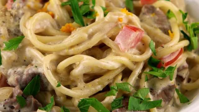 Spaghetti with mushroom sauce, tomatoes and parsley, restaurant food, loop