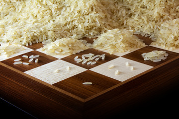 chessboard with growing heaps of rice grains, legend about the exponential growth
