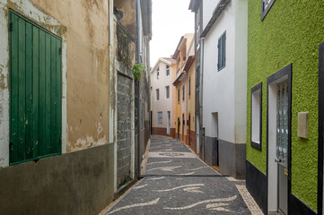 Fototapeta na wymiar Narrow street with old houses at Paul do Mar, Madeira.