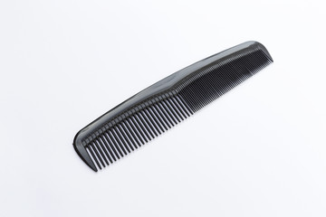 Black plastic comb on white background