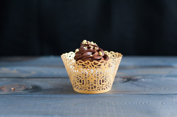 Wedding cupcake wrapped with a pattern is on the table
