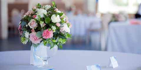 Wedding floristry. Beautiful lush bouquet on the table in restaurant