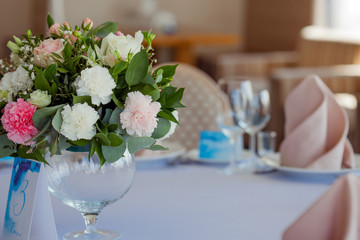 Wedding floristry. Beautiful lush bouquet on the table in restaurant