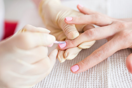 Manicure process in a beauty salon. Close up photo