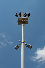 A lamp post with multiple different light sources