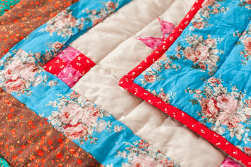 Patchwork quilt. Part of patchwork quilt as background. Flower print.