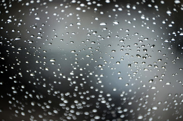 Abstract bokeh of light, blurred defocused lights of cars on a wet rainy road backgrounds.
