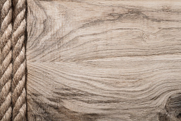 Vintage twisted flax cables on wooden board copy space
