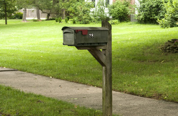 American outdoor metal mailbox on wooden support