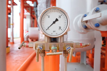 Pressure gauge, measuring instrument close up on oil and gas pipeline.