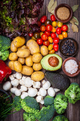 Assorted raw vegetables on wooden background