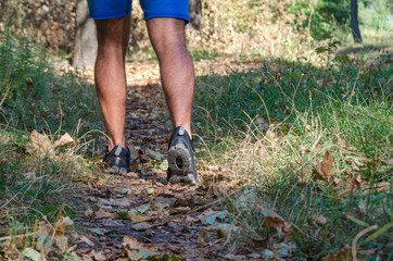 Young male cross country runner, legs and shoes detail.