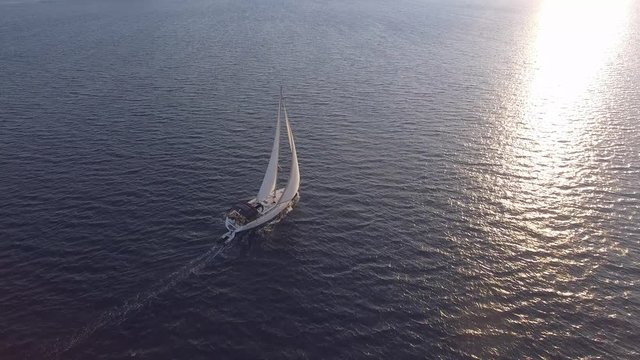 Bare boat sailing into the sun in Mediterranean Sea Aerial