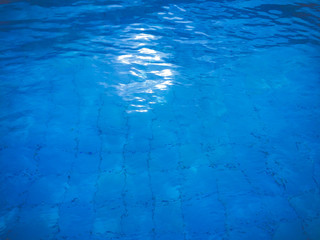 Blue ripped water in swimming pool.water in the pool at noon.