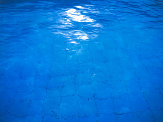 Blue ripped water in swimming pool.water in the pool at noon.
