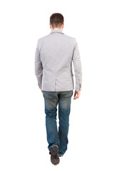 Back view of walking businessman.  Rear view people collection. Backside view of person. Isolated over white background.  A man in a gray jacket leaves the frame.