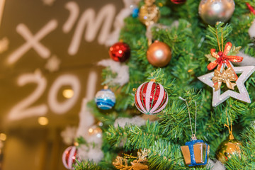 Decorated Christmas tree on blurred, sparkling