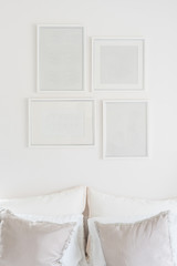 white blank picture frames hanging on white