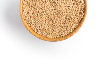 Mustard seeds into a bowl in white background