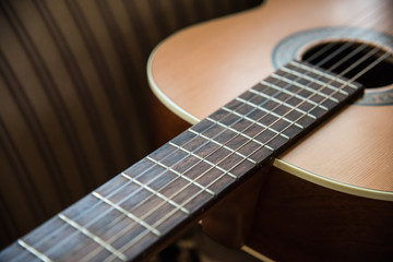 Obraz premium Close-Up of a Wooden Acoustic Guitar