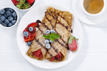 crepes with fresh berries and chocolate sauce for breakfast