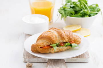 croissant with salted salmon and fresh arugula