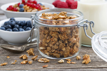 jar with granola, milk, and fresh berries 