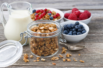 jar with granola, milk, and fresh berries 
