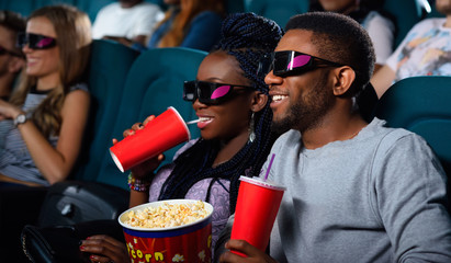 Young African couple at the cinema