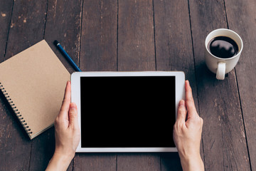 Asian woman using tablet on table in coffee shop with vintage 