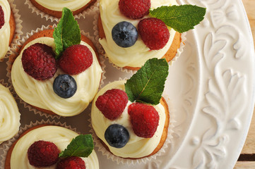 cakes with raspberries and blueberries on a plate