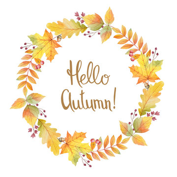 Hello autumn watercolor round frame with colored leaves and hand lettering.