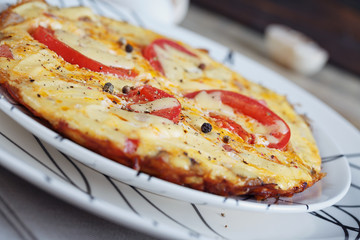 Omelet with onion, tomatoes and mushrooms