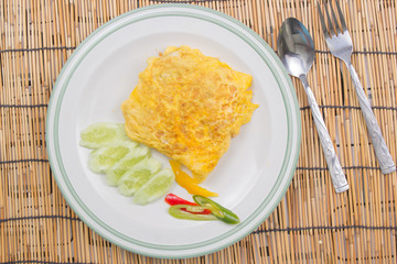 Fired rice with bacon Wrap eggs on white plate