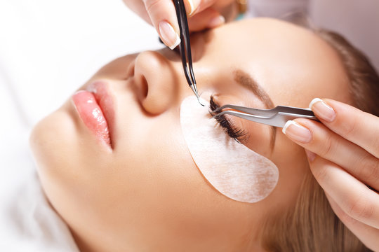 Eyelash Extension Procedure. Woman Eye with Long Eyelashes. Lashes, close up, selected focus.