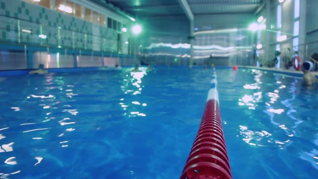 Plastic lanes in swimming pool. Lanes of competition swimming pool. Large indoor swimming pool for training. Swimming pool with clear blue water and markup