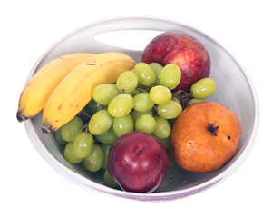 Organic fruits in berry bowl separated on white background