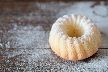Mini gluten-free cake on an old wooden table.