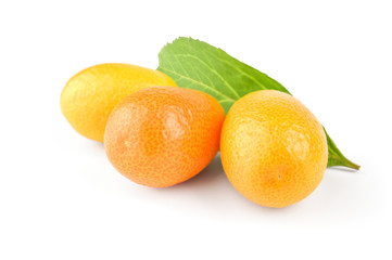 Three fresh fruit kumquat and green leaf isolated on a white background
