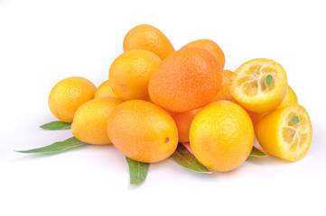 Pile of kumquat and two its half isolated on white background with leaves
