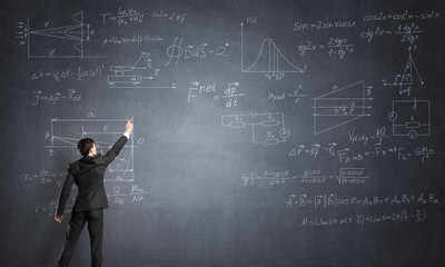 Man writing on blackboard