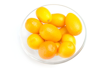 Tasty kumquat in the bowl on white
