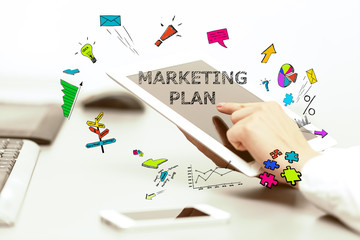 Young business woman pointing at Marketing Plan concept and uses