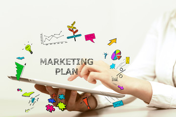 Young business woman pointing at Marketing Plan concept and uses