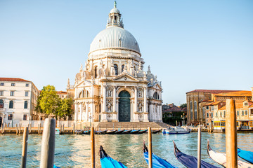 Venice cityscape view on Santa Maria della Salute basilica with gondolas on the Grand canal in...
