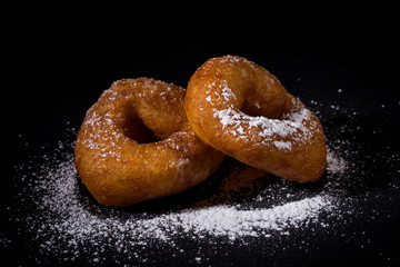 Sprinkling sugar powder on donut