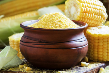 Raw corn grits or polenta in a clay pot, selective focus © 5ph
