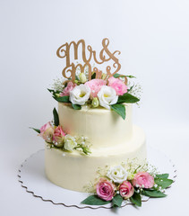 two  layered wedding cream cheese cake with roses and eustoma