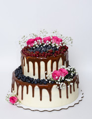 two layered color drip wedding cake with bilberries, red currant